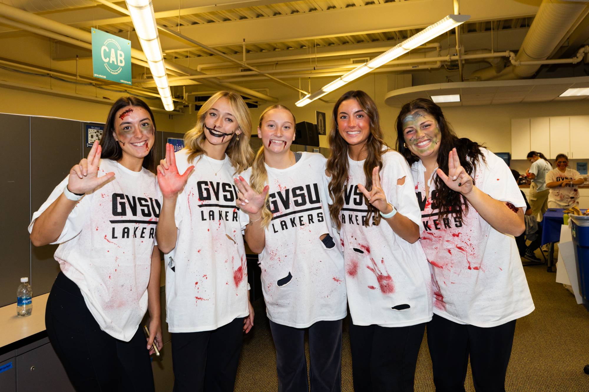 a group of girls dressed up as zombies pose for picture